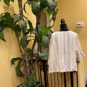 Women’s white eyelet three-quarter sleeve top.